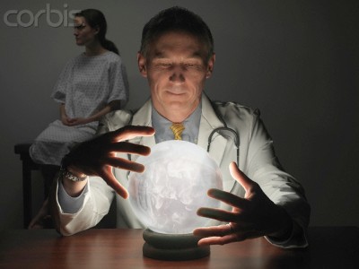 Massachusetts, USA --- Doctor Peering into Crystal Ball While Patient Waits --- Image by © Cary Wolinsky/Aurora Photos/Corbis